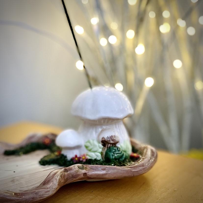 A close up shot of a ceramic mushroom incense burner